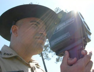 photo of police officer holding a radar gun